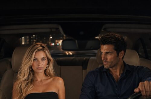 Blonde woman and dark-haired man sitting in a car at night while the man drives