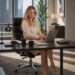 Blonde businesswoman sitting on an office desk with a dark-haired man standing close to her