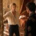 Two men confronting each other in an ornate royal bedchamber