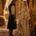 Blonde woman facing a blond man in an ornate royal chamber