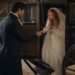 Aiden helping nervous bride Tess step out of a dark carriage after their wedding