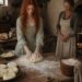 Tess kneading dough at a flour-covered kitchen table while an older woman watches