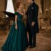 Aiden holding Viktoria's wrist as she confronts him in an emerald evening gown
