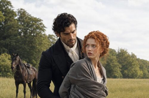 Aiden holding frightened Tess from behind in an open field with a saddled black horse nearby
