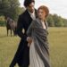 Aiden holding frightened Tess from behind in an open field with a saddled black horse nearby