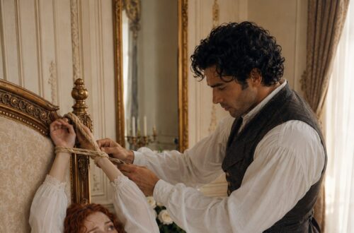 Aiden tying Tess's bound wrists to the carved headboard while she lies on the bed